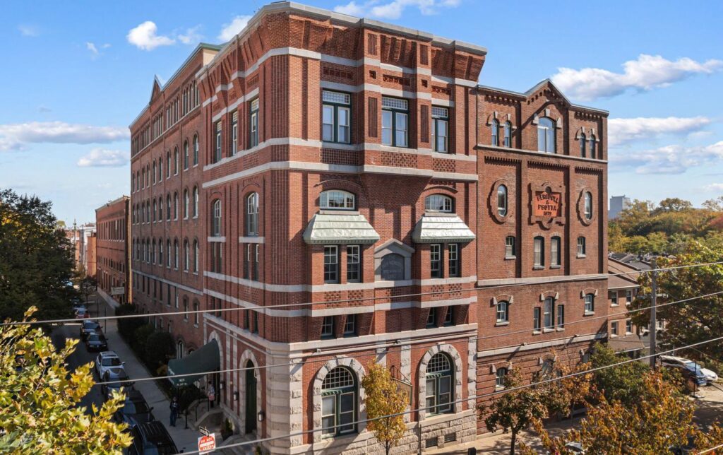Exterior of The Brewery Condos building in Philadelphia, showing its historic brick façade and architectural details.