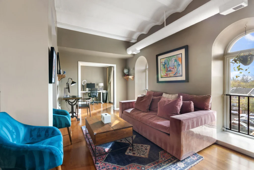 Living and dining area in the Brewery Condo building featuring exposed brick ceiling