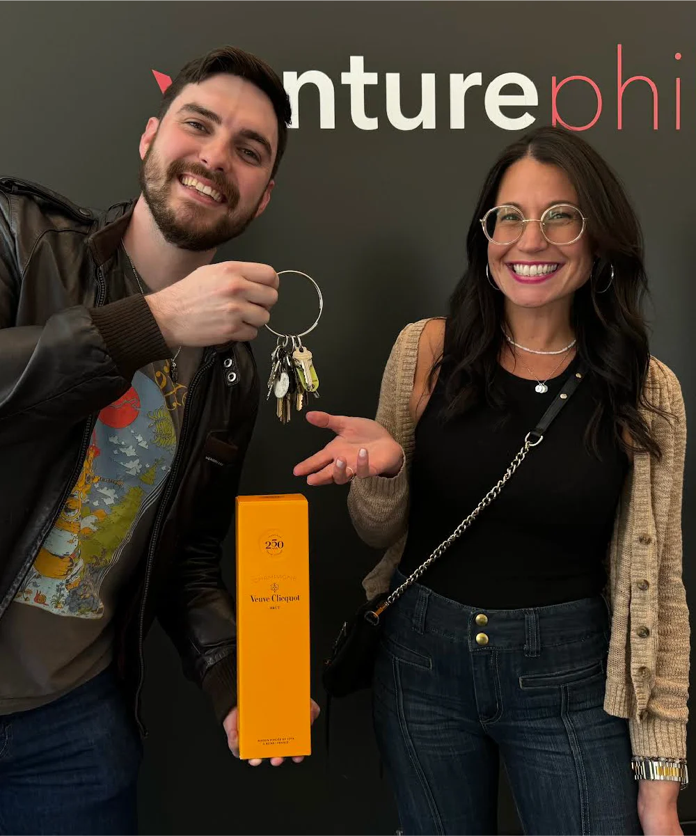 Realtor handing keys to a happy client celebrating the purchase of her new home, showcasing a successful real estate journey