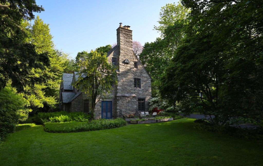 Designed in the Cotswolds style by the esteemed architectural firm Duhring, Okie, and Ziegler in 1928, this stunning 7-bedroom, 4 1/2-bath property on one of the most iconic residential streets in Chestnut Hill