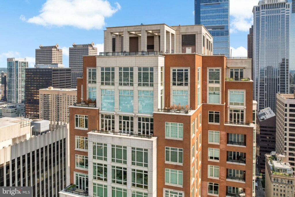 Modern luxury high-rise at 10 Rittenhouse Square in Rittenhouse Square Philadelphia, featuring brick and limestone exterior, large windows, private terraces, and Center City skyline views.
