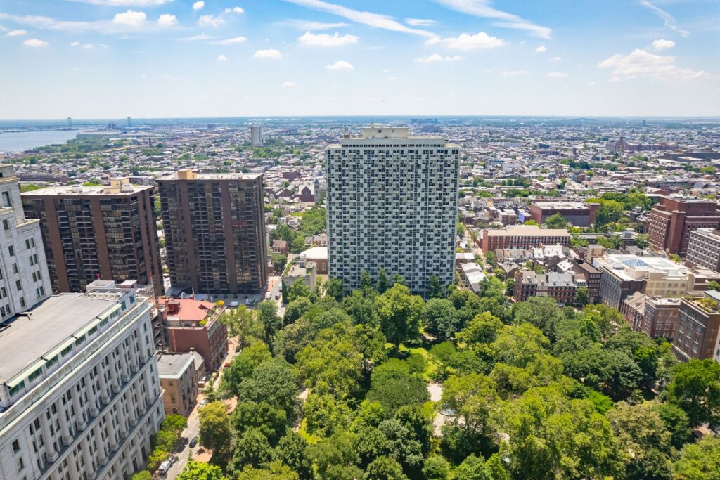 Panoramic view from Hopkinson House overlooking Washington Square Park and the Philadelphia skyline, with lush green treetops and surrounding city buildings.